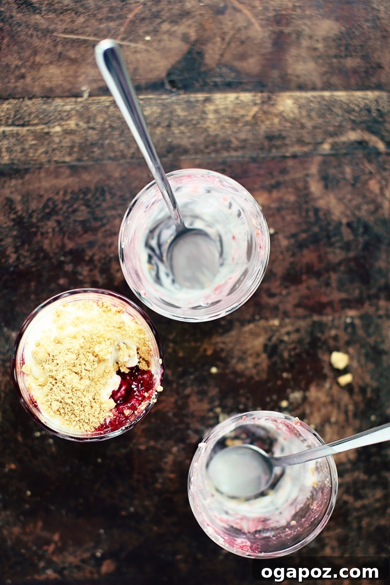 Effortless Raspberry Cheesecake Delights 3 Layers of no-bake raspberry cheesecake parfait in a glass