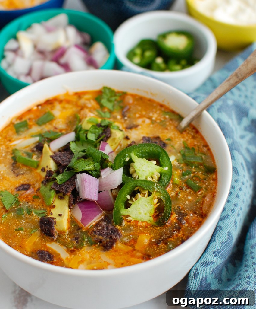 Effortless Instant Pot White Chicken Chili 2 A bowl of Instant Pot White Chicken Chili garnished with fresh herbs and sour cream, ready to be enjoyed.