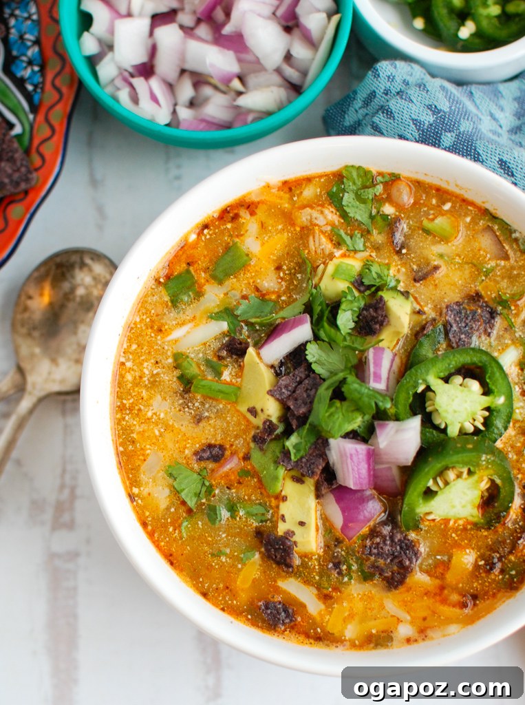 Effortless Instant Pot White Chicken Chili 3 Instant Pot White Chicken Chili served in a white bowl with a spoon, highlighting its hearty texture.