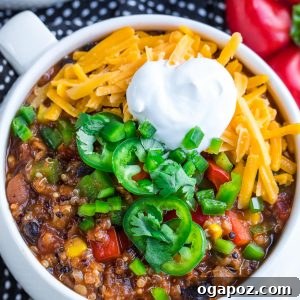 10 Ultimate Instant Pot Chili Recipes 5 A colourful bowl of vegetarian quinoa chili, topped with fresh cilantro and lime wedges.