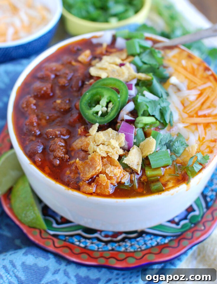 10 Ultimate Instant Pot Chili Recipes 6 Classic Instant Pot Beef Chili in a bowl, ready to be served, with a spoon for scooping.