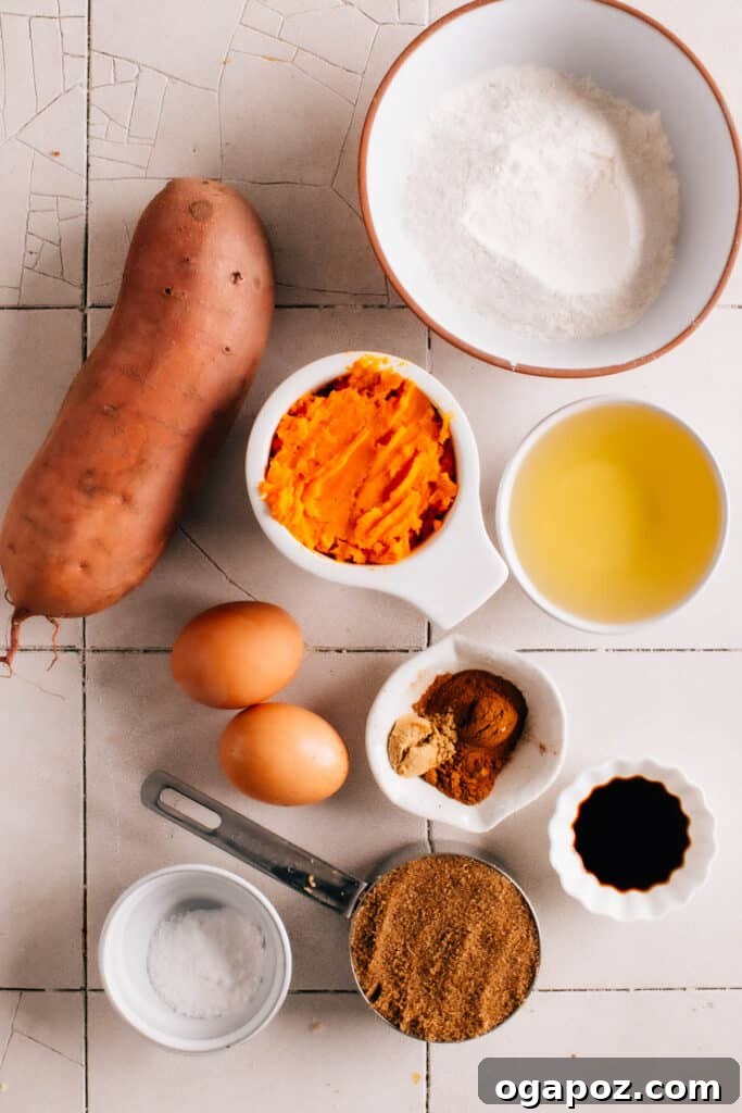 Fresh sweet potatoes and other baking ingredients laid out on a kitchen counter, ready for cupcake preparation.