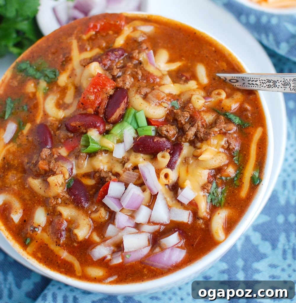 Ultimate Instant Pot Chili Mac 5 Instant Pot Chili Mac with a spoon in the bowl, ready to eat
