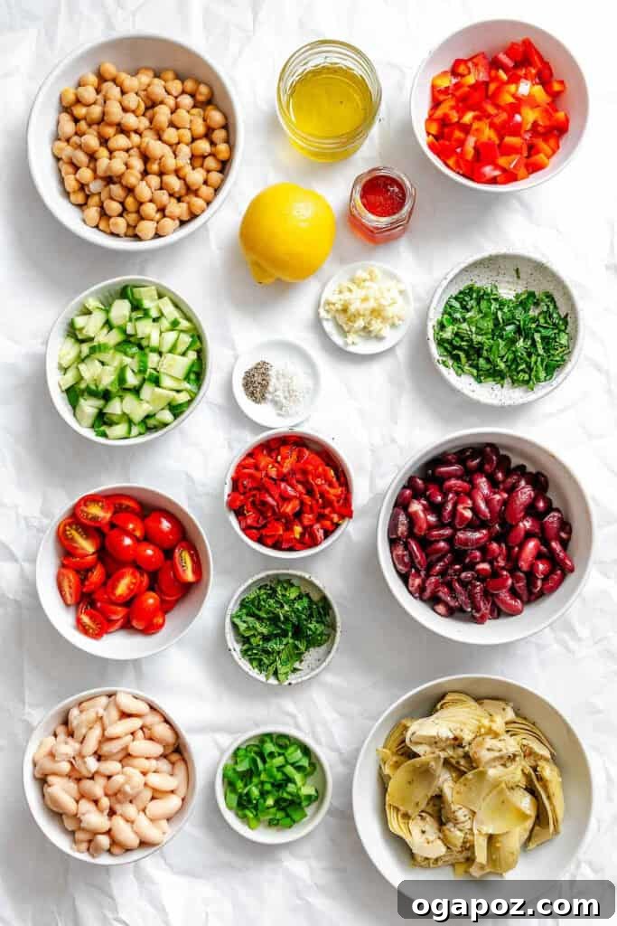 Vibrant Mediterranean Three Bean Salad 3 Individual ingredients laid out for Mediterranean Three Bean Salad preparation, including beans, fresh vegetables, and dressing components.