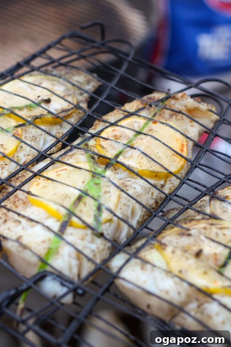 Grilled Cod fillet with grill marks and fresh garnishes.
