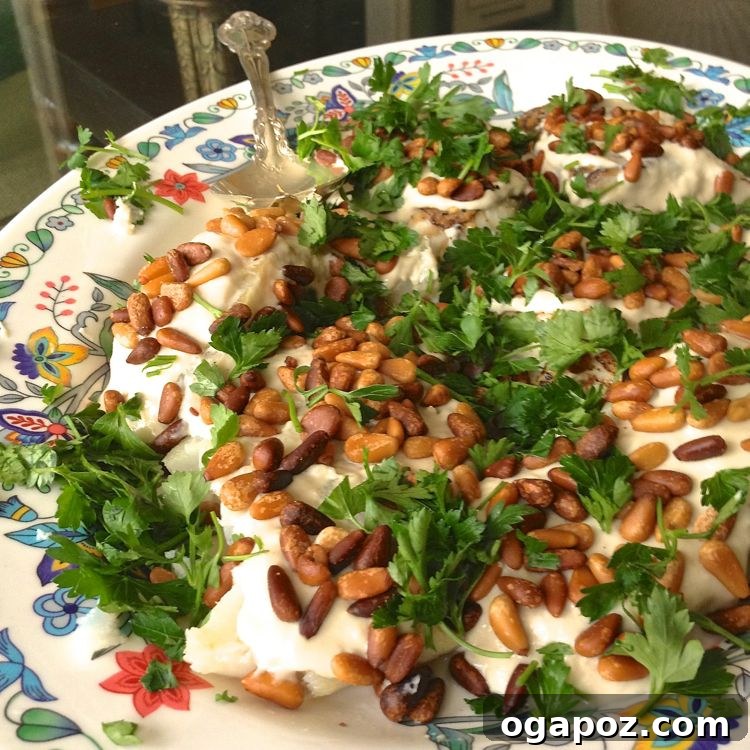 Easy Baked Fish Recipe with tahini sauce and toasted pine nuts.