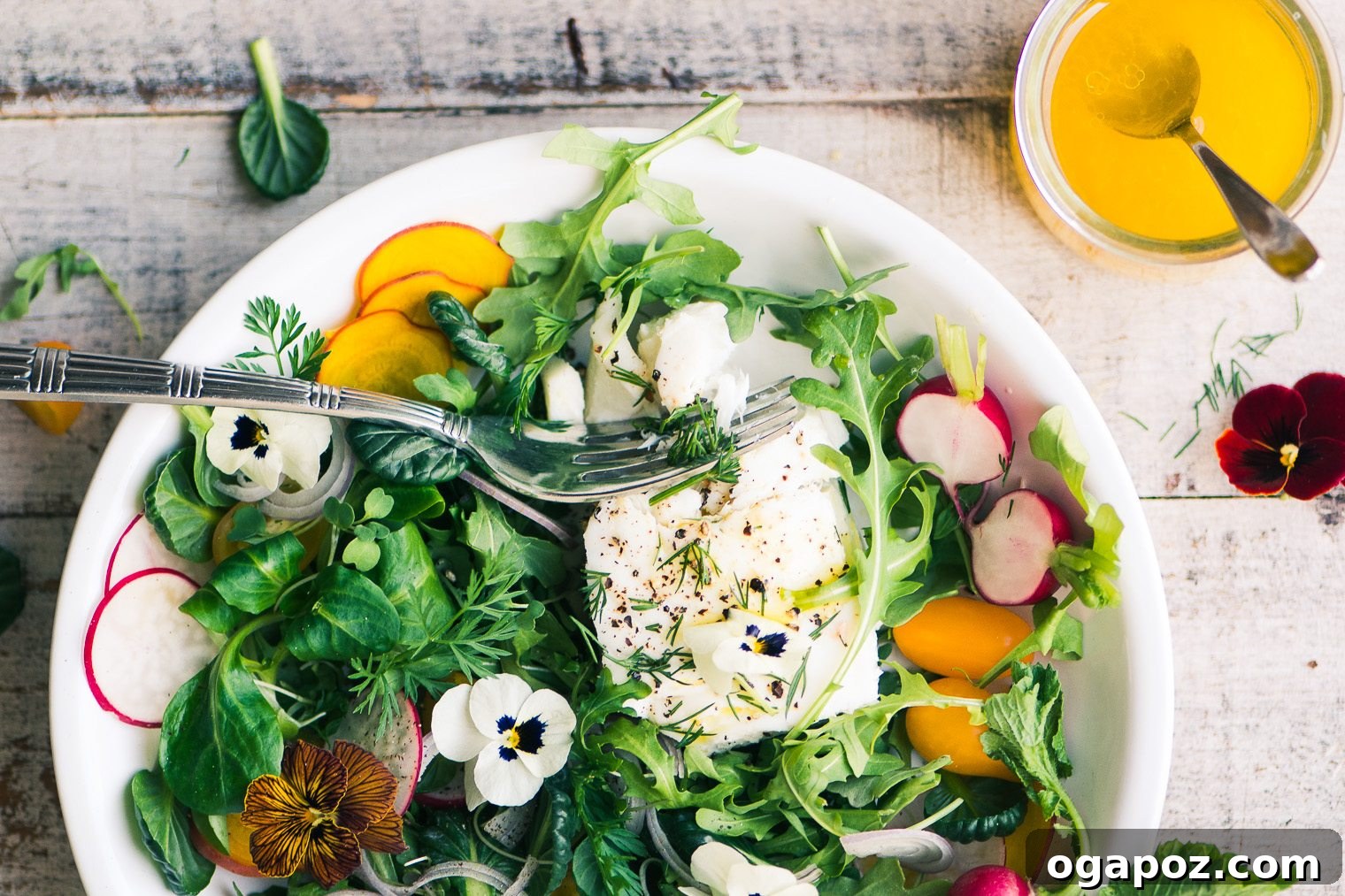 Poached Halibut Salad with Meyer Lemon Vinaigrette, served on a bed of greens.