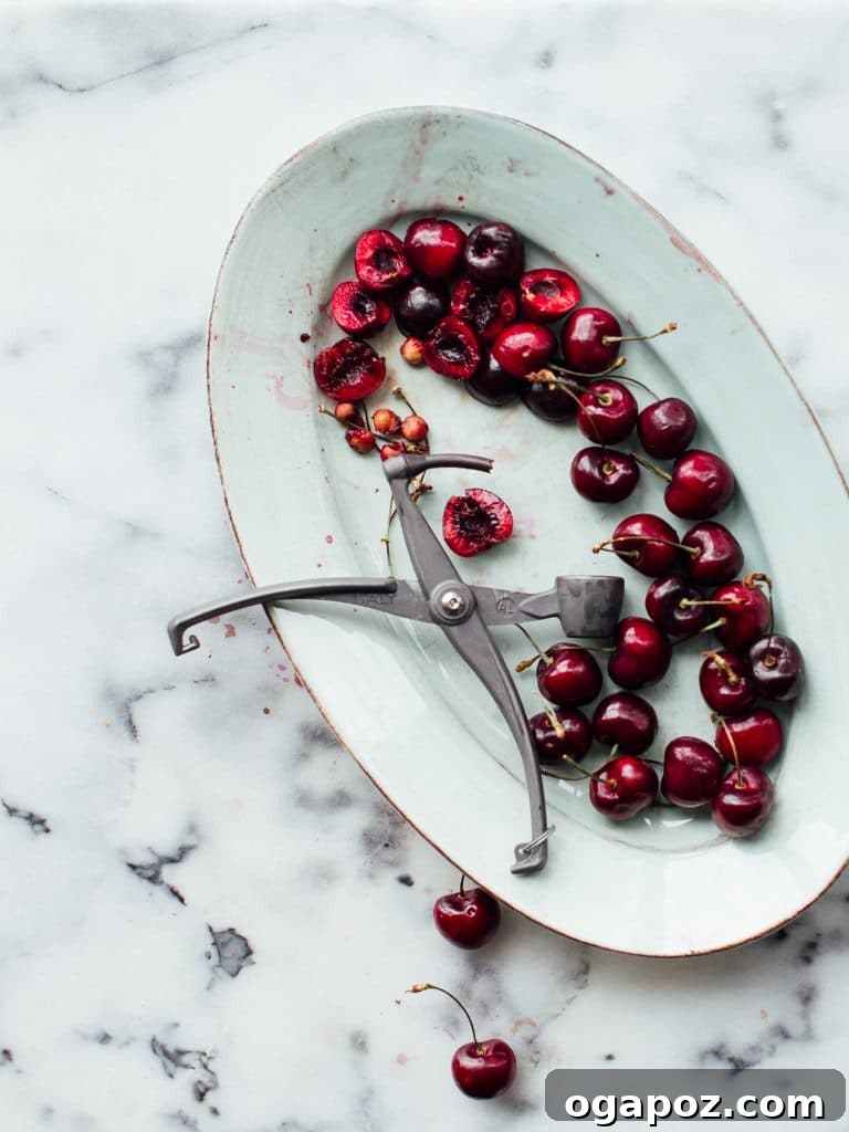 3-Ingredient Spiked Pops 3 Close-up of fresh cherries being pitted, an essential step for homemade cherry winesicles.