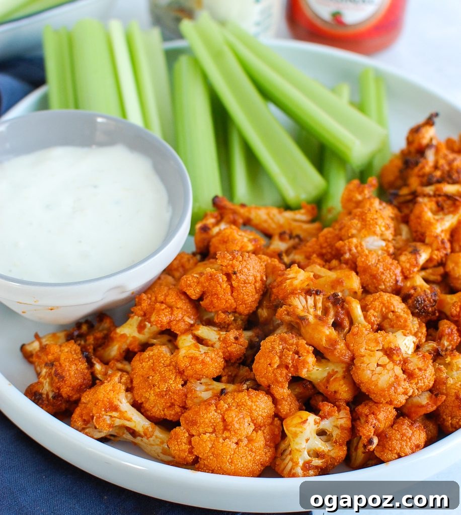 Air-Fried Spicy Cauliflower Wings 2 Crispy Air Fryer Buffalo Cauliflower on a white plate with blue cheese dressing and celery sticks