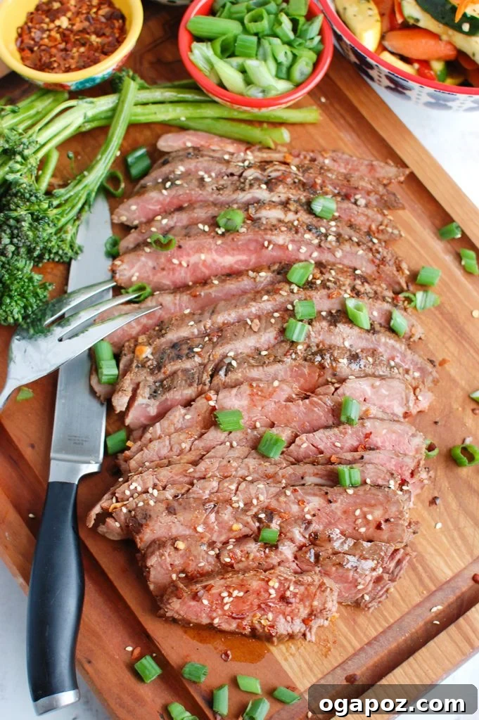Sweet and Savory Asian Flank Steak 2 Grilled Asian Marinated Flank Steak on a cutting board, ready to be sliced