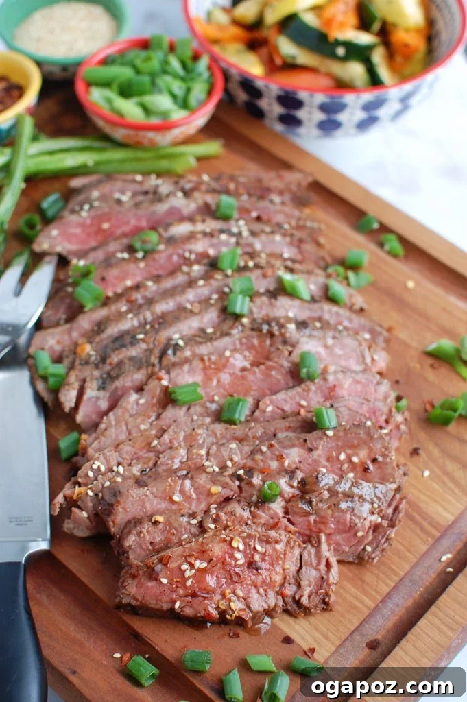 Sweet and Savory Asian Flank Steak 4 Asian Marinated Flank Steak being sliced against the grain on a cutting board