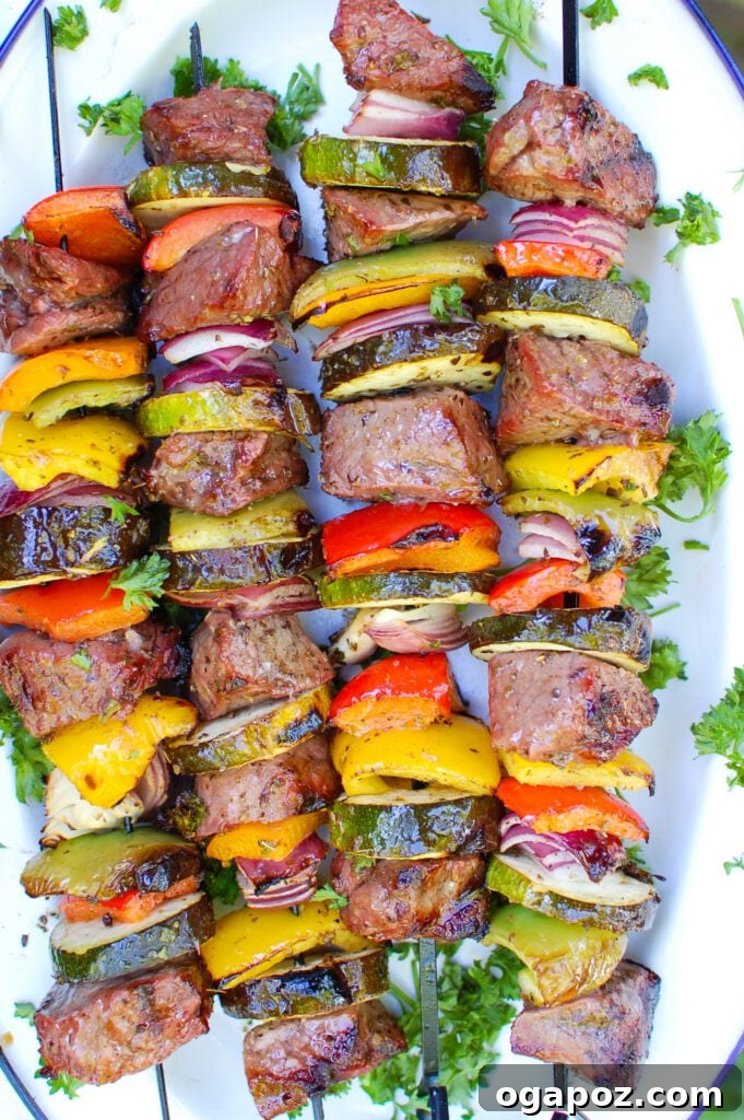 Grilled Mediterranean Beef Skewers 3 Close-up of raw Mediterranean Beef Kabobs ingredients before grilling, showcasing marinated beef cubes and various chopped vegetables