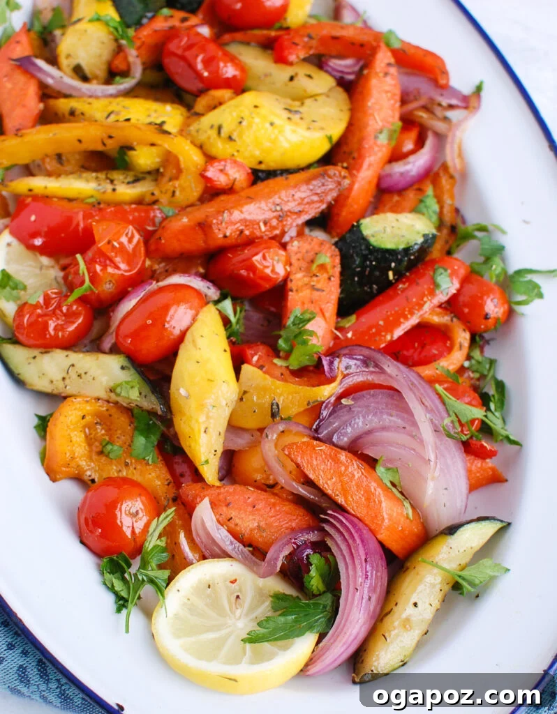 Sun-Kissed Mediterranean Medley 2 Vibrant Mediterranean Roasted Vegetables served in a white platter, showcasing a rich blend of colors and textures from various roasted seasonal vegetables, garnished with fresh herbs.