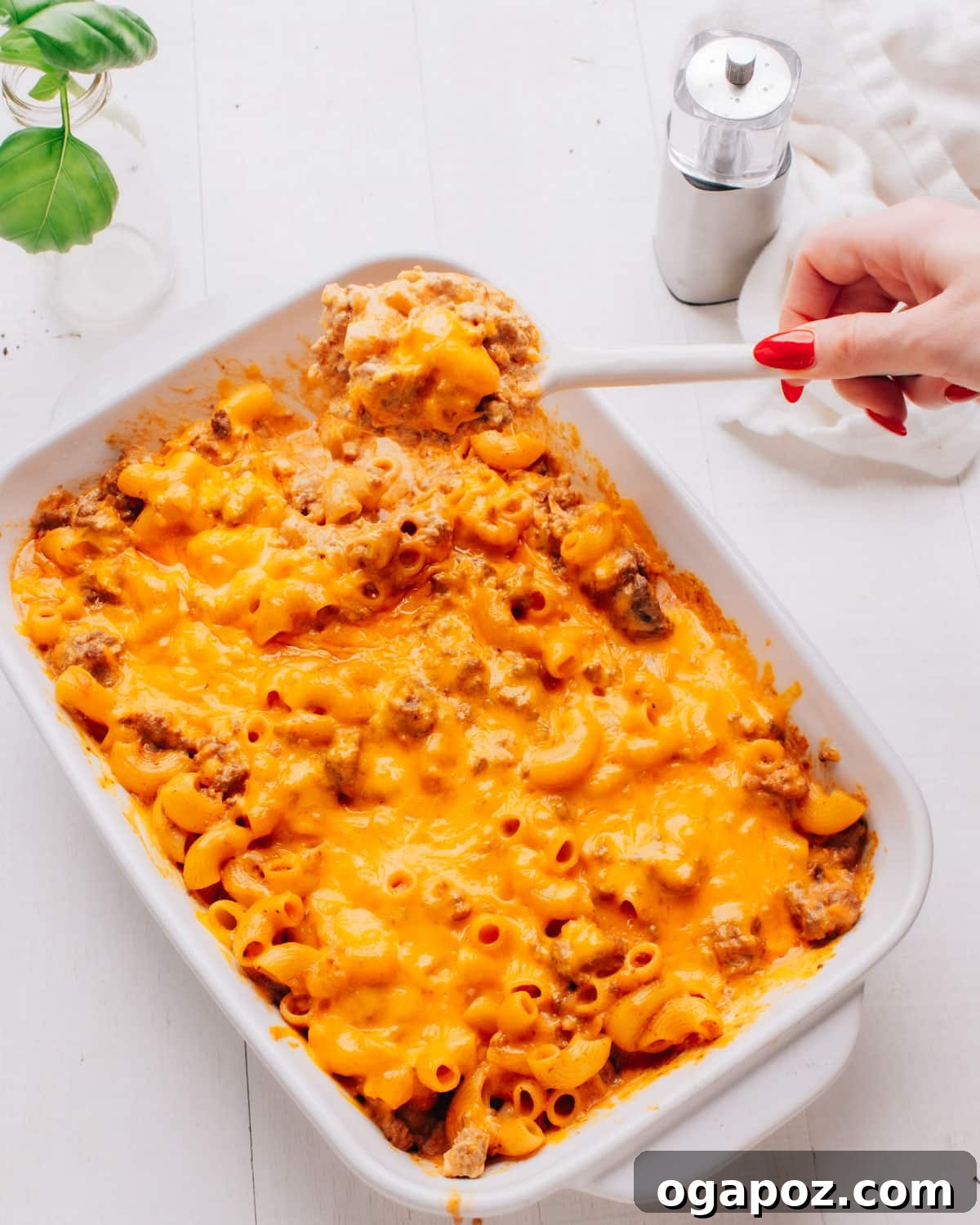 Ultimate Easy Cheeseburger Bake 7 Lifting a spoonful of cheeseburger casserole.