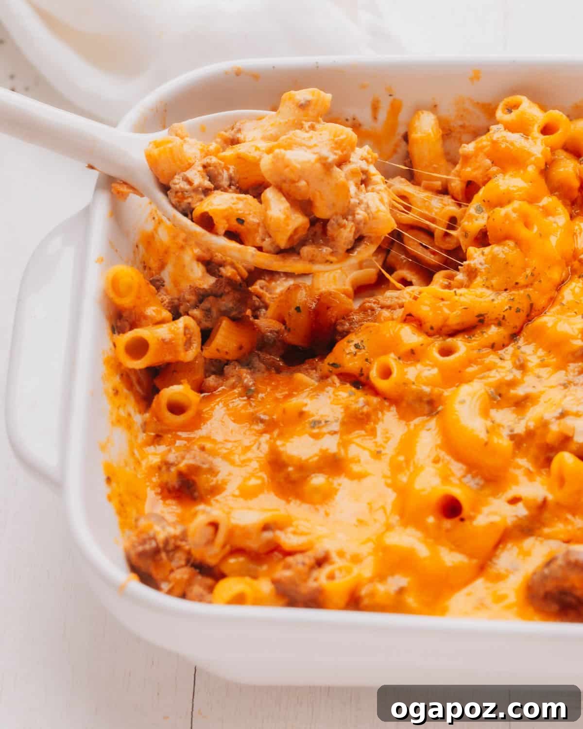Ultimate Easy Cheeseburger Bake 8 Lifting a spoonful of cheeseburger casserole.