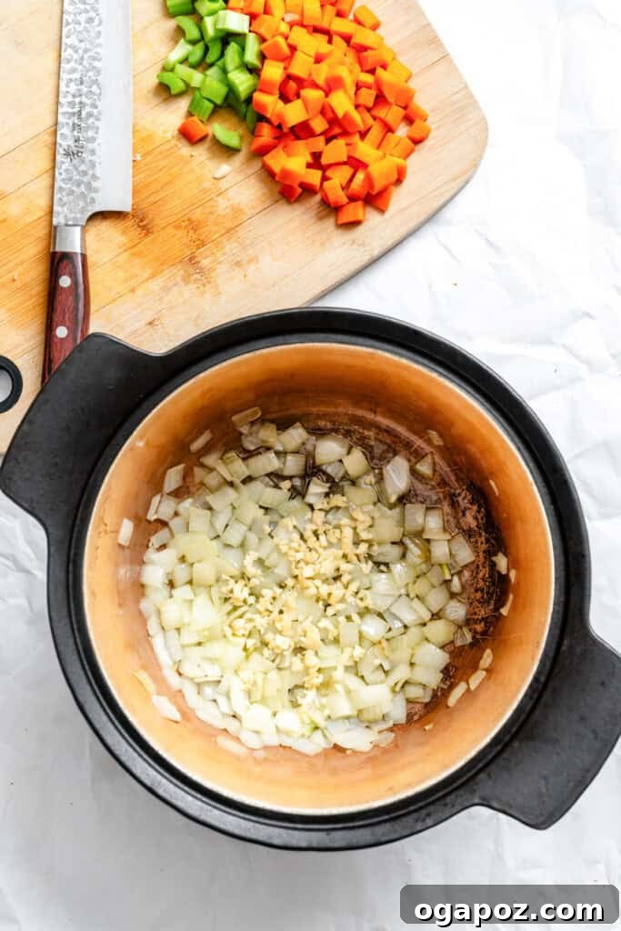The Ultimate Homemade Vegetarian Chili 5 Onions sauteing in olive oil in a pot for chili