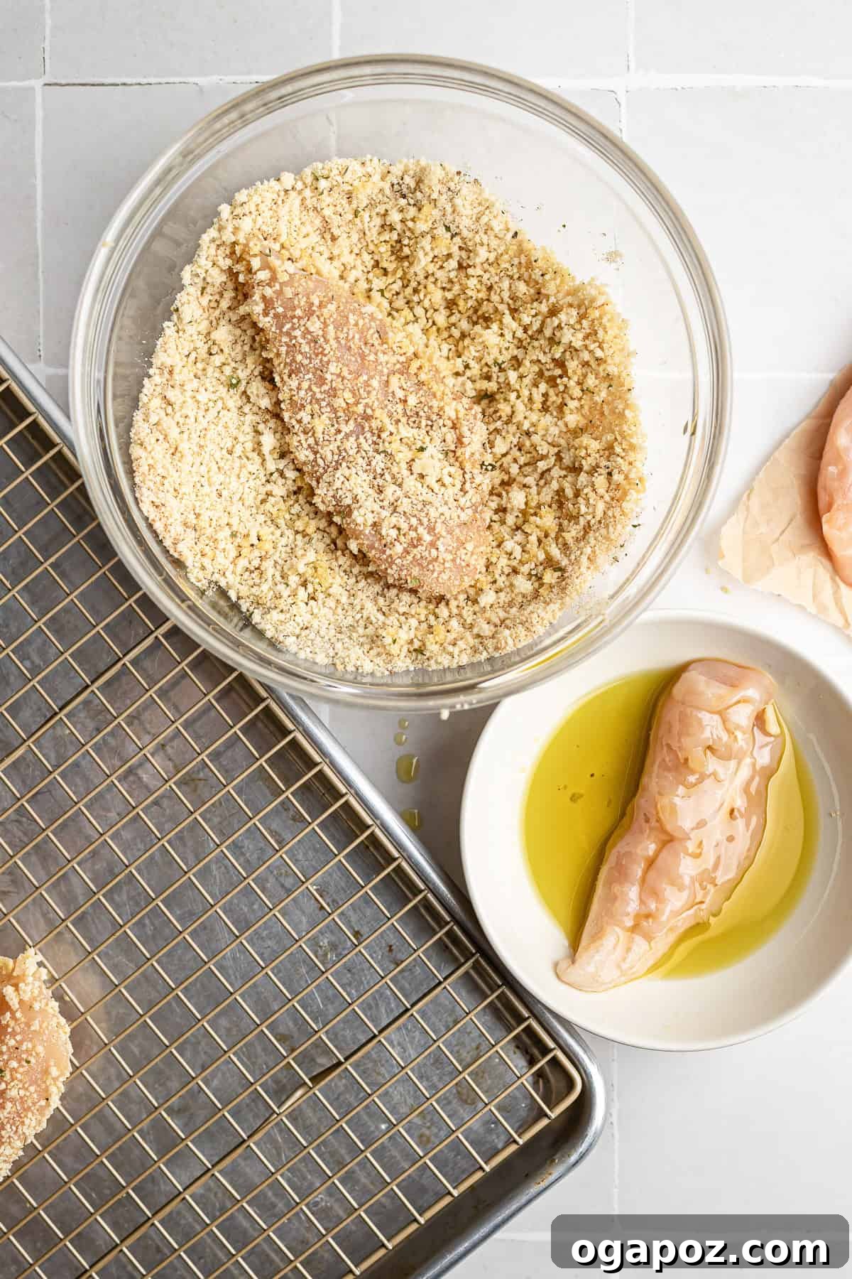 Golden Crispy Oven Baked Chicken Tenders 5 step 2 – dredging chicken tenders in olive oil before coating