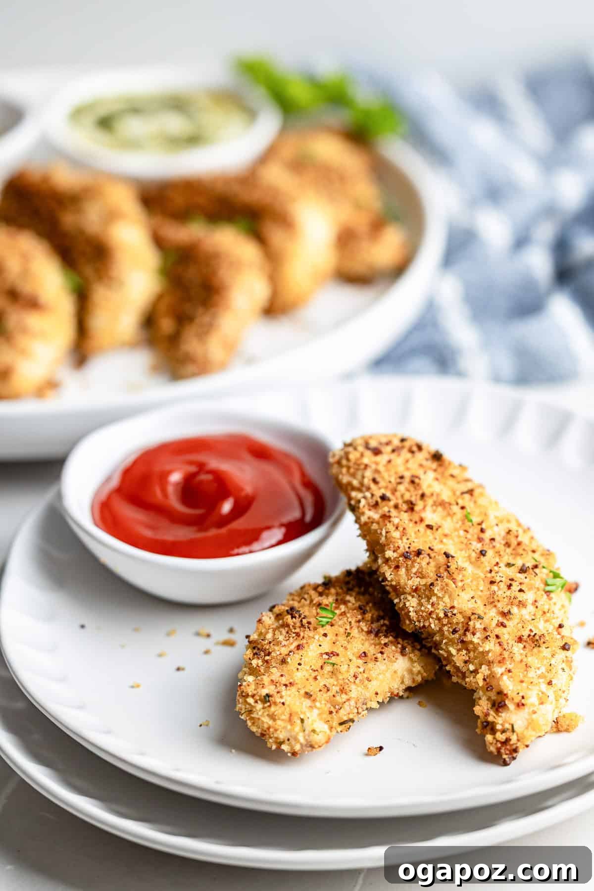 Golden Crispy Oven Baked Chicken Tenders 9 Plate of baked chicken tenders with dipping sauce, ready to eat.