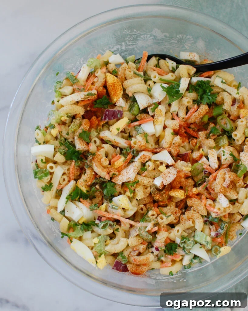 Creamy Macaroni Egg Salad 4 Macaroni Egg Salad in a clear glass bowl, ready to serve