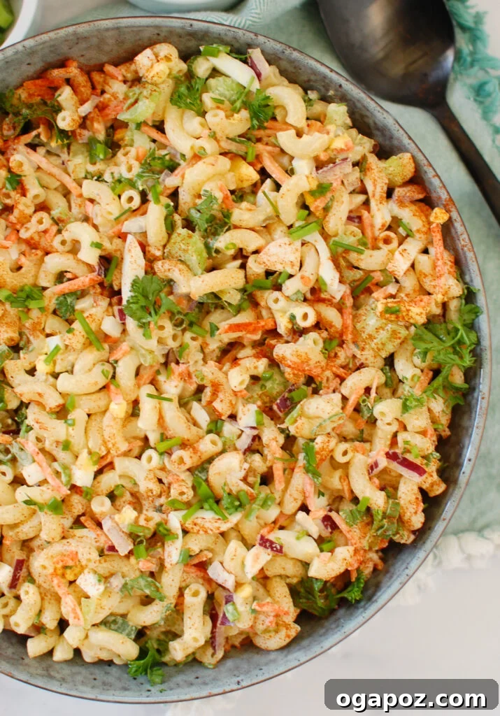 Creamy Macaroni Egg Salad 5 Easy Macaroni Egg Salad being mixed in a large bowl