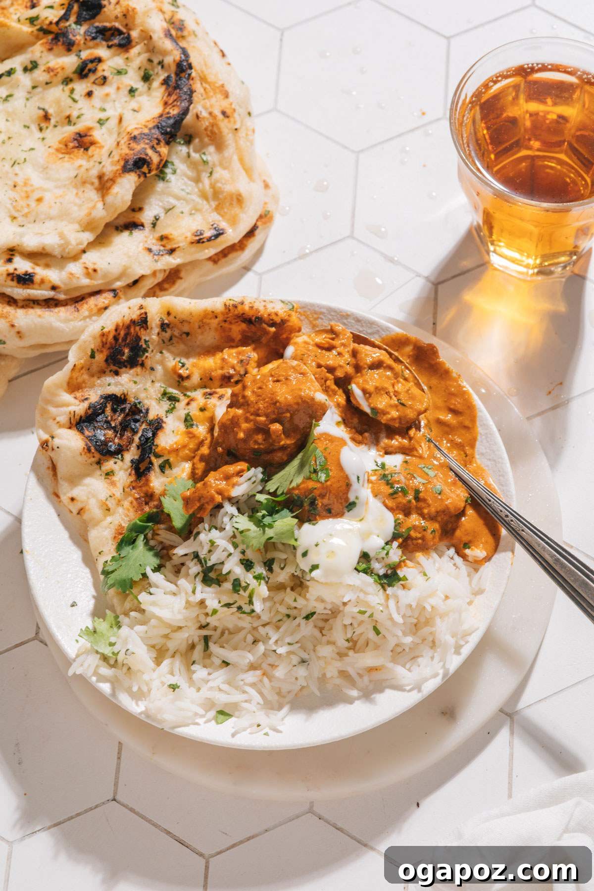 Perfect Butter Chicken From Your Kitchen Outshining Restaurants 12 Butter chicken served with basmati rice and garlic naan, garnished with cilantro.