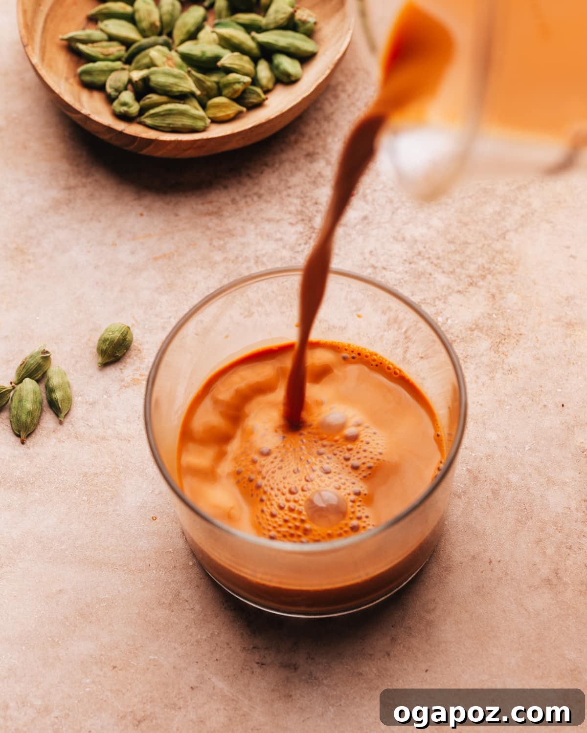 Perfect Butter Chicken From Your Kitchen Outshining Restaurants 13 Hot chai being poured into a glass, creating steam.