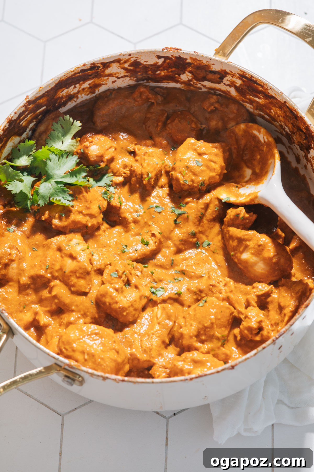Perfect Butter Chicken From Your Kitchen Outshining Restaurants 14 Butter chicken simmering in a saucepan, garnished with fresh cilantro.