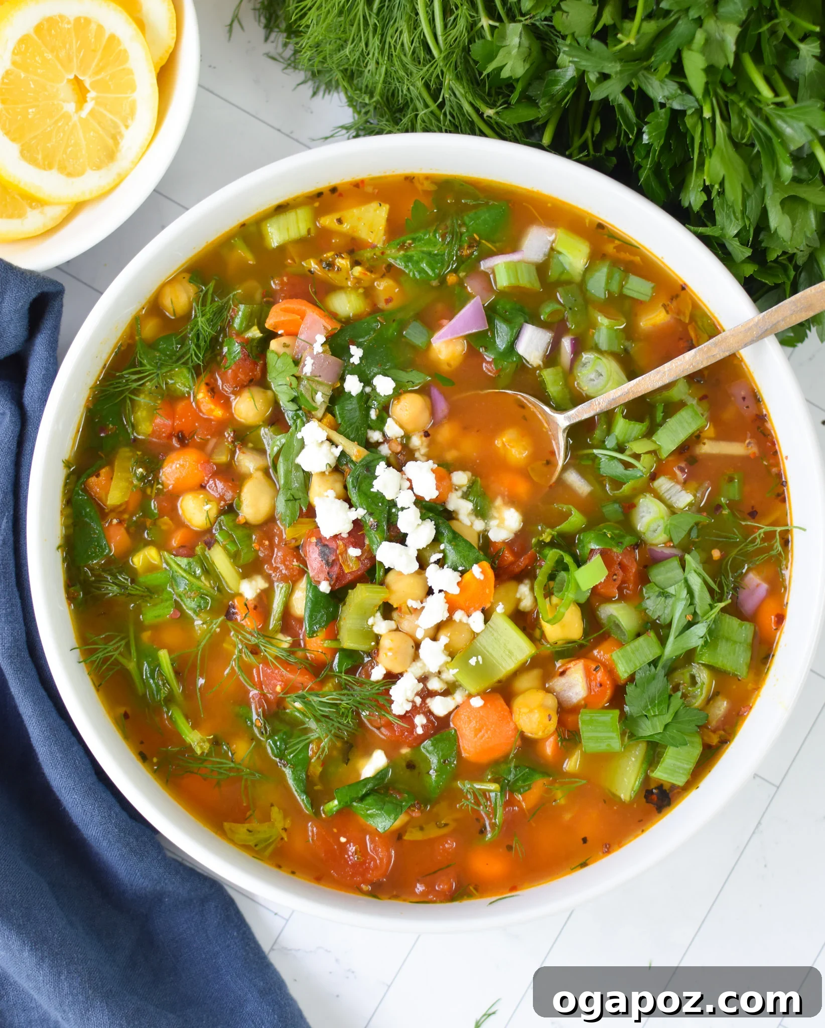 One-Pot Chickpea Comfort 2 A vibrant bowl of Garbanzo Bean Soup with a spoon, garnished with fresh herbs, ready to be enjoyed.