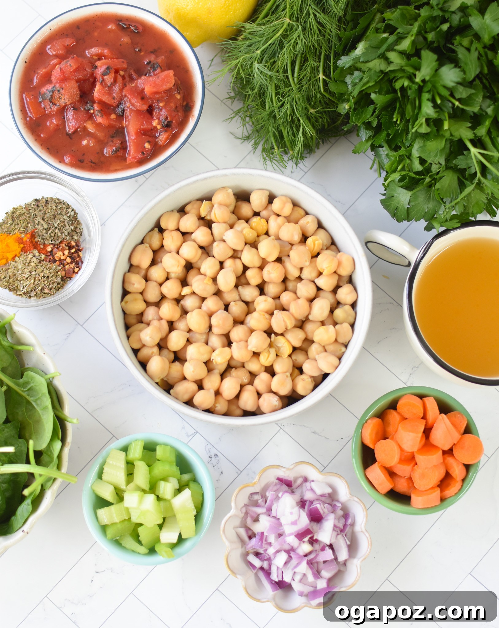 One-Pot Chickpea Comfort 4 Fresh ingredients for Garbanzo Bean Soup laid out, including carrots, celery, onions, canned chickpeas, and various spices.