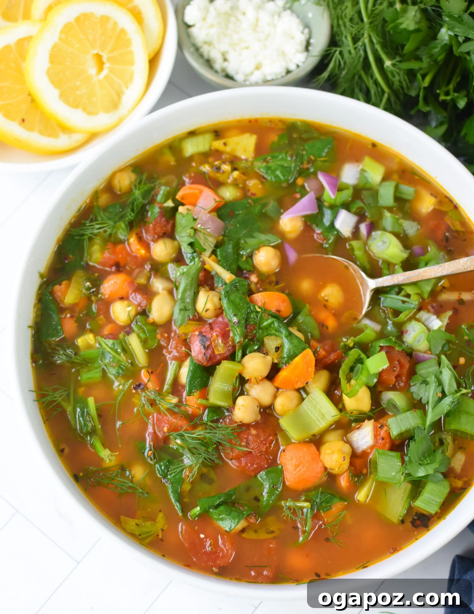 One-Pot Chickpea Comfort 5 Close-up of Garbanzo Bean Soup in a bowl with a spoon, highlighting the rich texture and colorful ingredients.