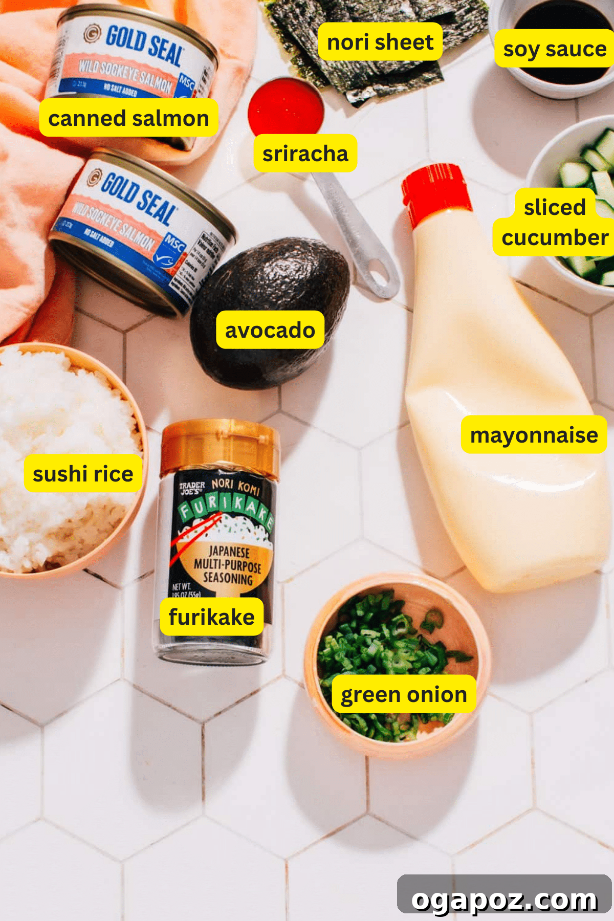 Ingredients laid out for baked salmon rice muffins including sushi rice, canned salmon, mayonnaise, sriracha, soy sauce, and nori sheets.