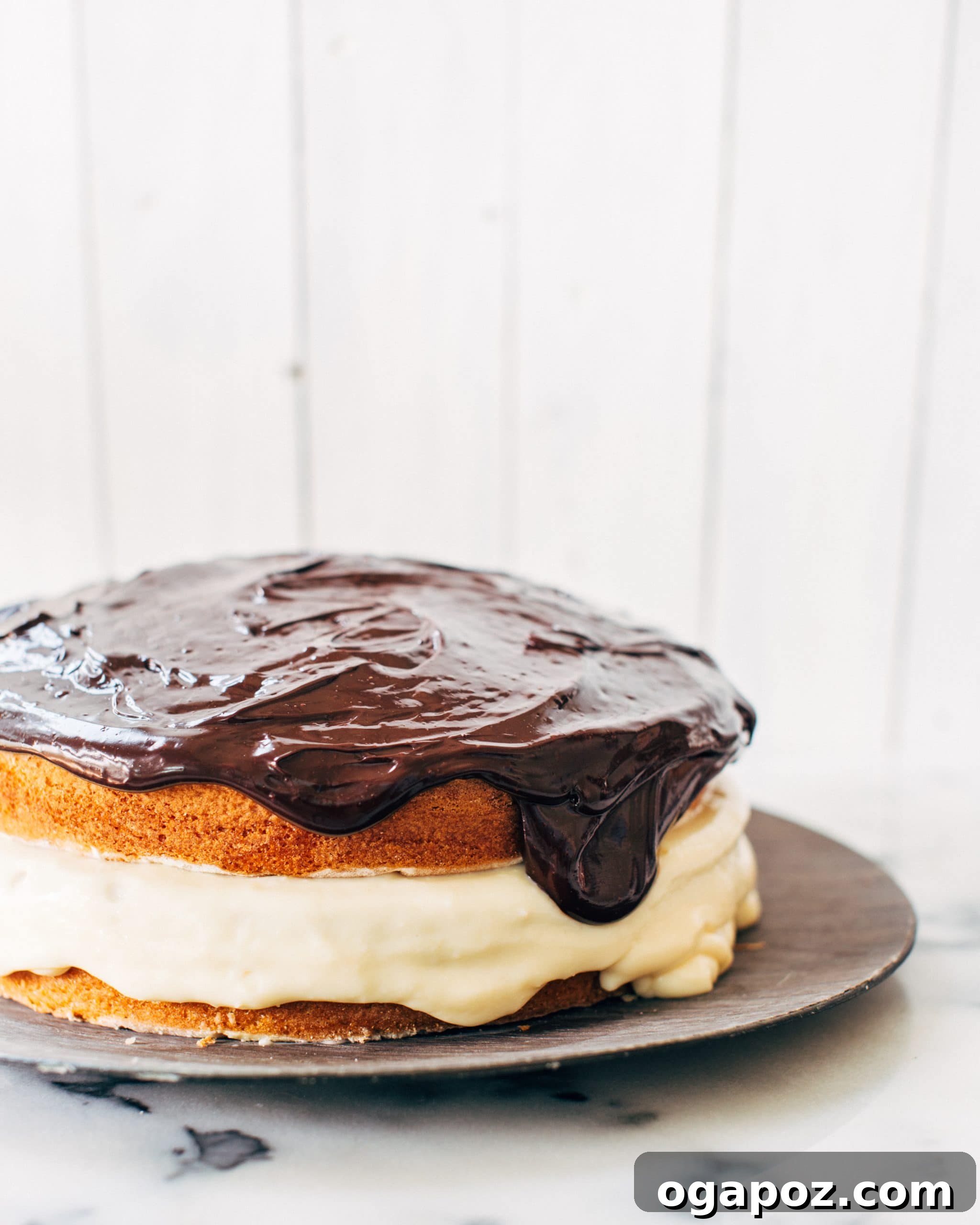 Boston's Iconic Creamy Dream 3 Close-up of the Boston Cream Pie's interior, showing the thick layer of vanilla pastry cream.