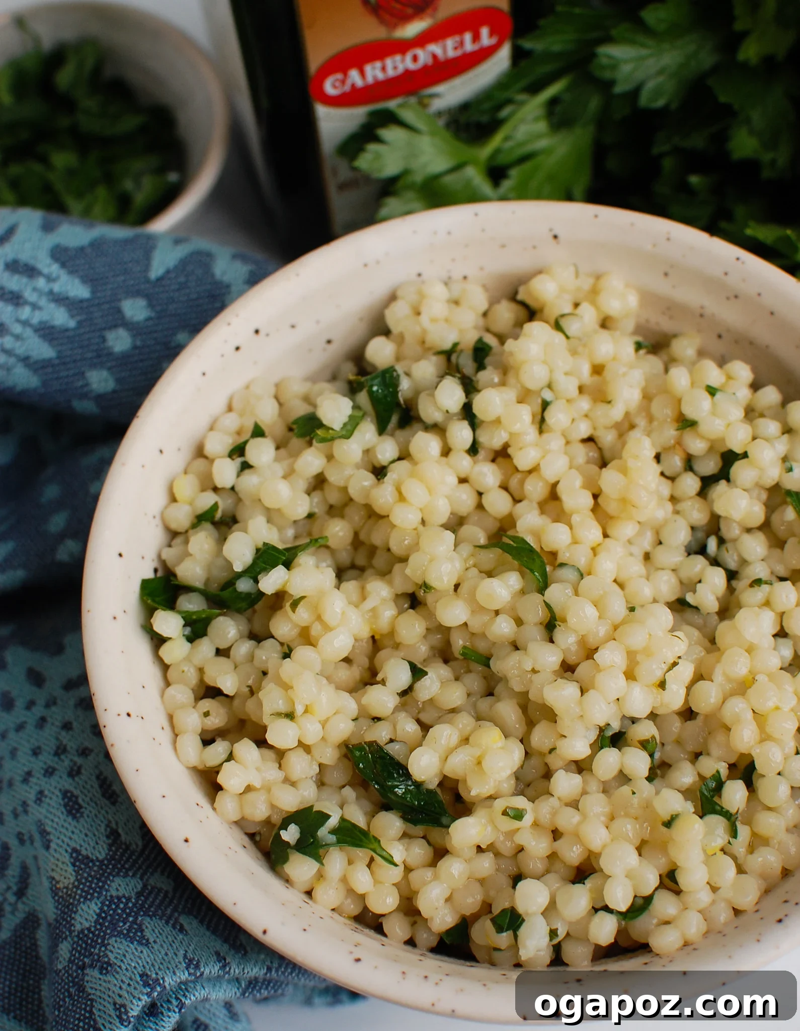 Sunshine Lemon Pearl Couscous 2 A vibrant bowl of Lemon Pearl Couscous, garnished with fresh herbs and lemon wedges, perfect for a light and flavorful meal.