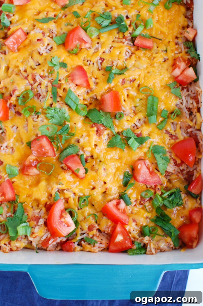 Fiesta Chicken Bake 5 Mexican Chicken Casserole in a rustic teal ceramic dish, ready to be served, garnished with fresh herbs.