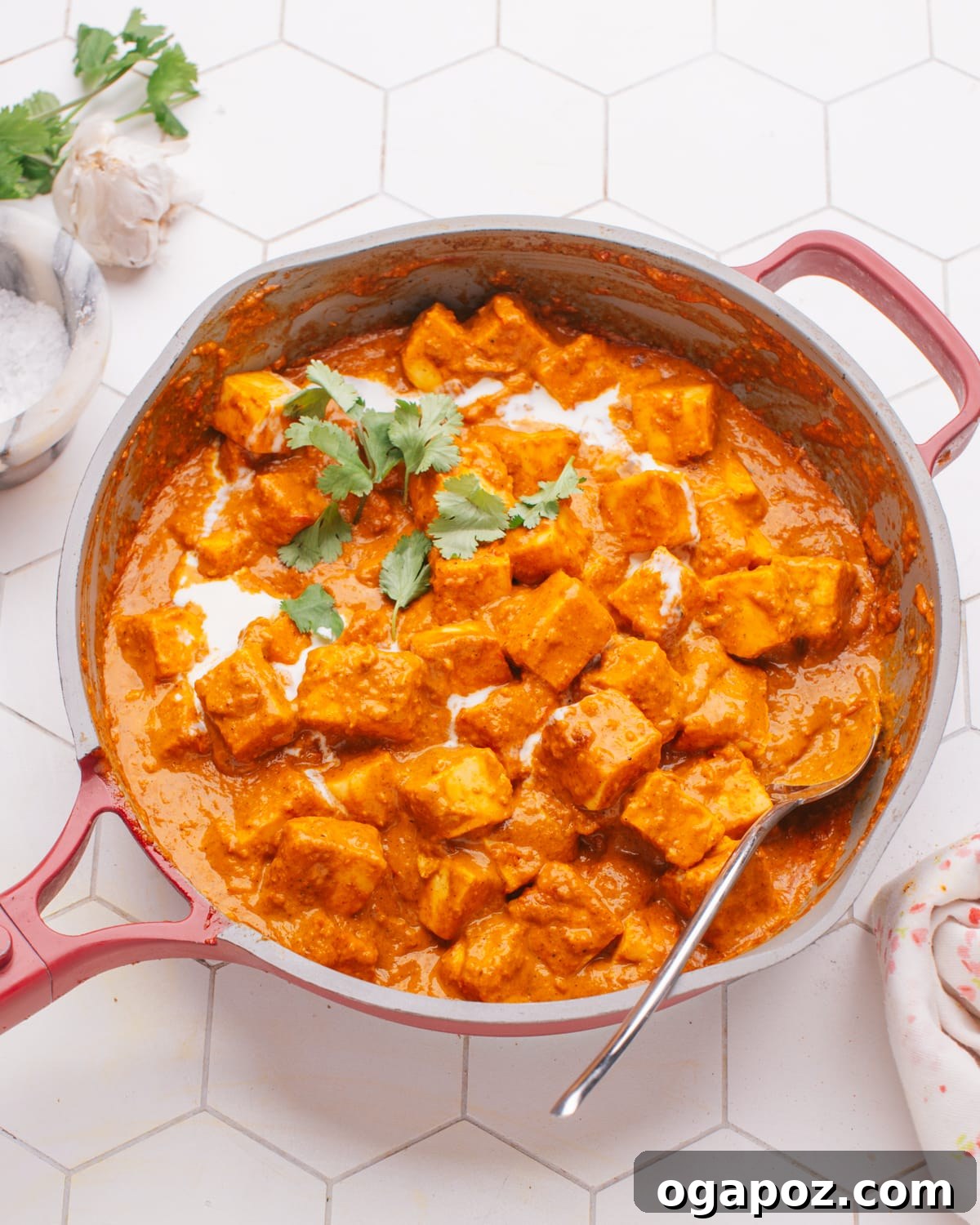 Creamy Butter Paneer 2 Rich and creamy Butter Paneer in a traditional Indian karahi, garnished with fresh cilantro.
