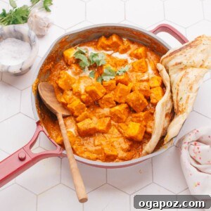 Homemade Butter Paneer served with fresh naan bread in a rustic setting.