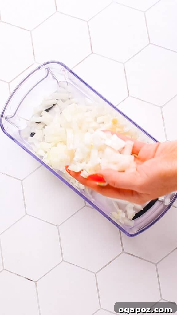 Creamy Butter Paneer 6 Finely diced onions in a food chopper, prepared for cooking in a delicious curry.