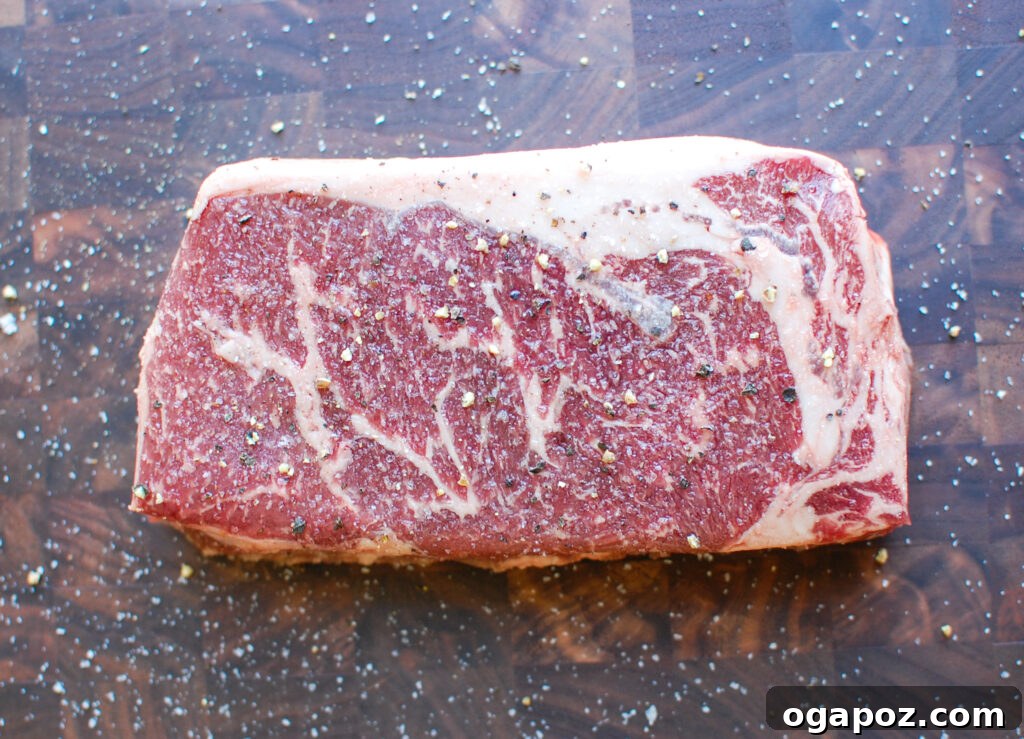 Grilled Ribeye with Lemon Garlic Butter 4 Lemon Garlic Butter Grilled Ribeye on a cutting board with sea salt flakes