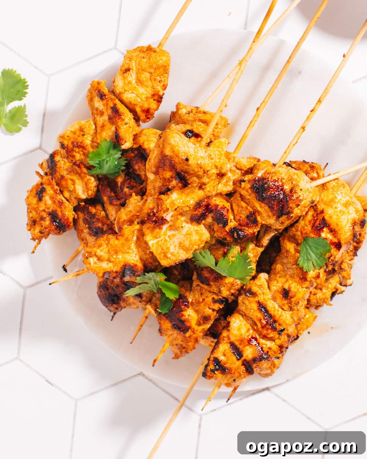 Ultimate Chicken Tikka: Grill, Oven, & Air Fryer 2 Delicious Chicken Tikka skewers garnished with fresh cilantro and lemon