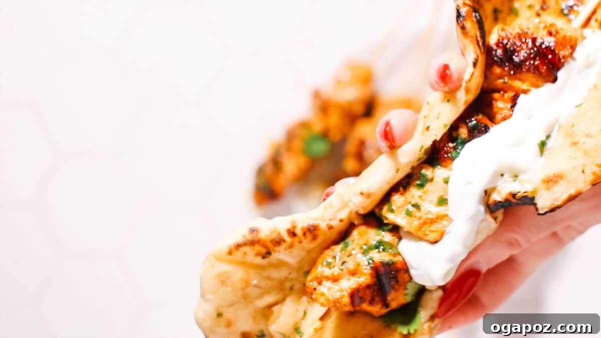 Ultimate Chicken Tikka: Grill, Oven, & Air Fryer 5 Chicken tikka pieces expertly threaded onto skewers, ready for cooking.