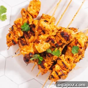 Finished Chicken Tikka Recipe on a plate garnished with cilantro.
