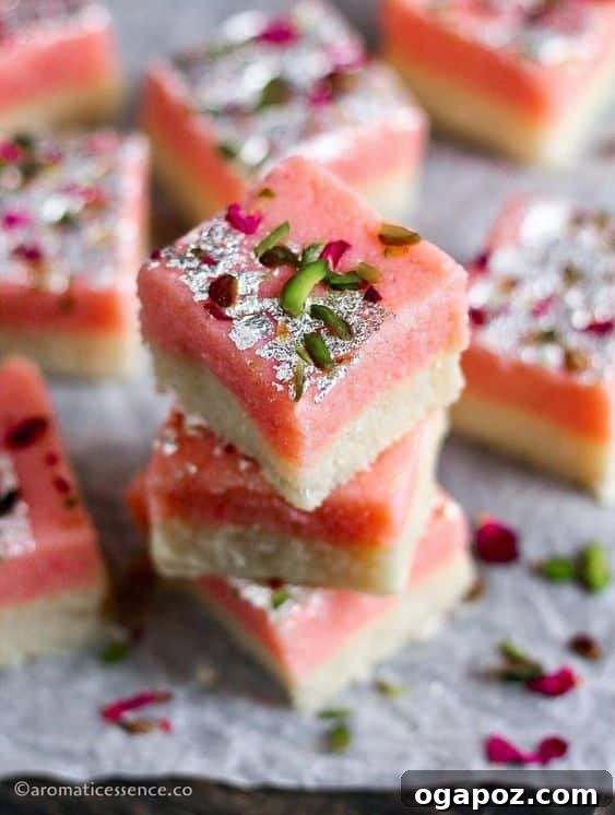 Easy Indian Desserts That Wow 15 Pretty squares of Coconut Burfi, a popular Indian sweet often made with condensed milk or khoya for a rich, sweet flavor.