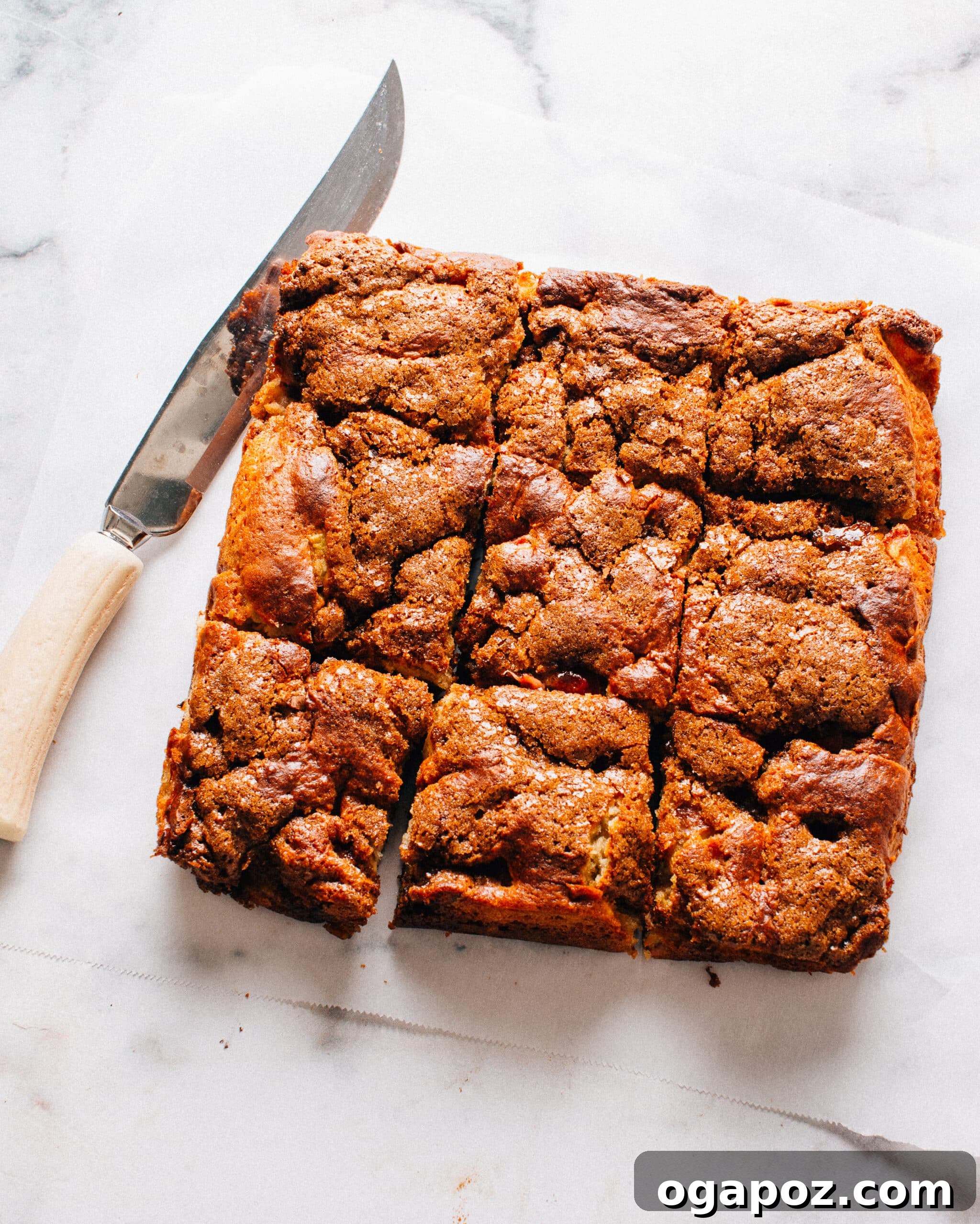 Our Go-To Easy Rhubarb Recipes 12 Strawberry Rhubarb Cake with a rich brown sugar streusel topping, showcasing a beautifully mottled, moon-like surface.