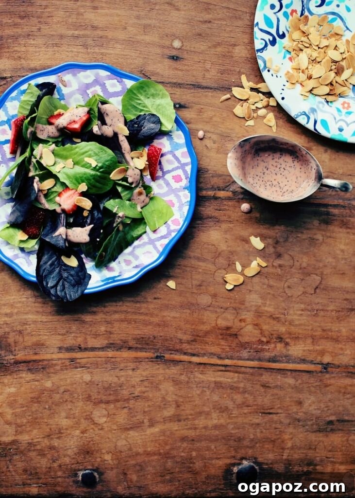 Our Go-To Easy Rhubarb Recipes 13 Fresh strawberry salad with a vibrant rhubarb dressing, garnished with toasted nuts and feta cheese.