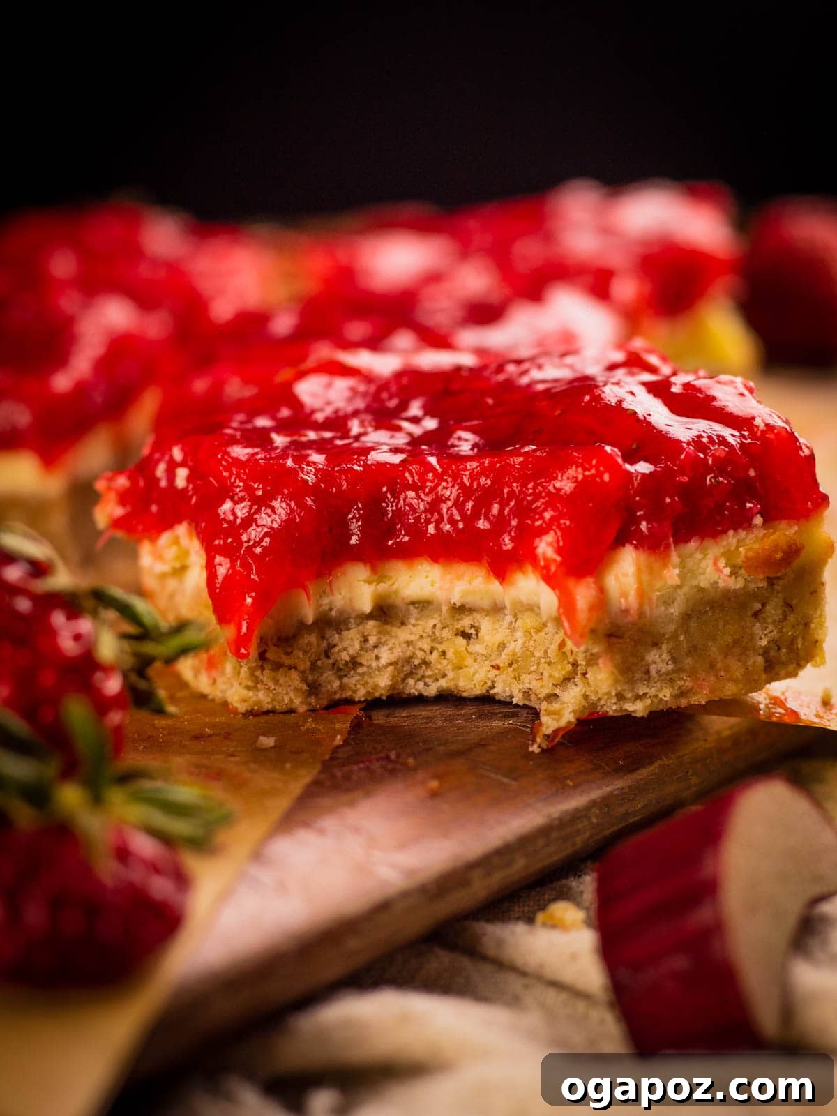 Our Go-To Easy Rhubarb Recipes 17 Strawberry Rhubarb Cheesecake Bars with a golden shortbread crust and a thick, vibrant, swirled topping.