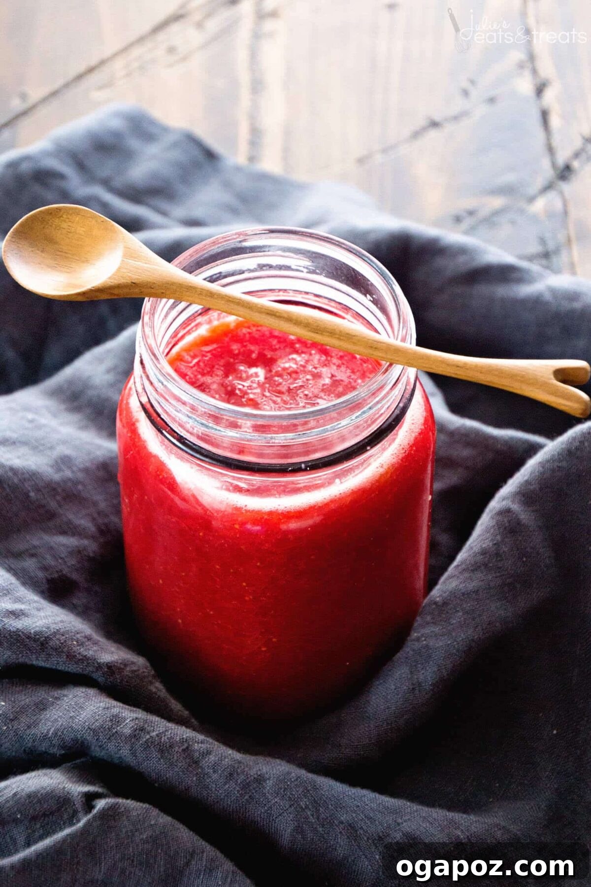 Our Go-To Easy Rhubarb Recipes 18 A jar of homemade Quick Rhubarb Jam, showing its bright pink color and lovely chunky texture, with toast in the background.