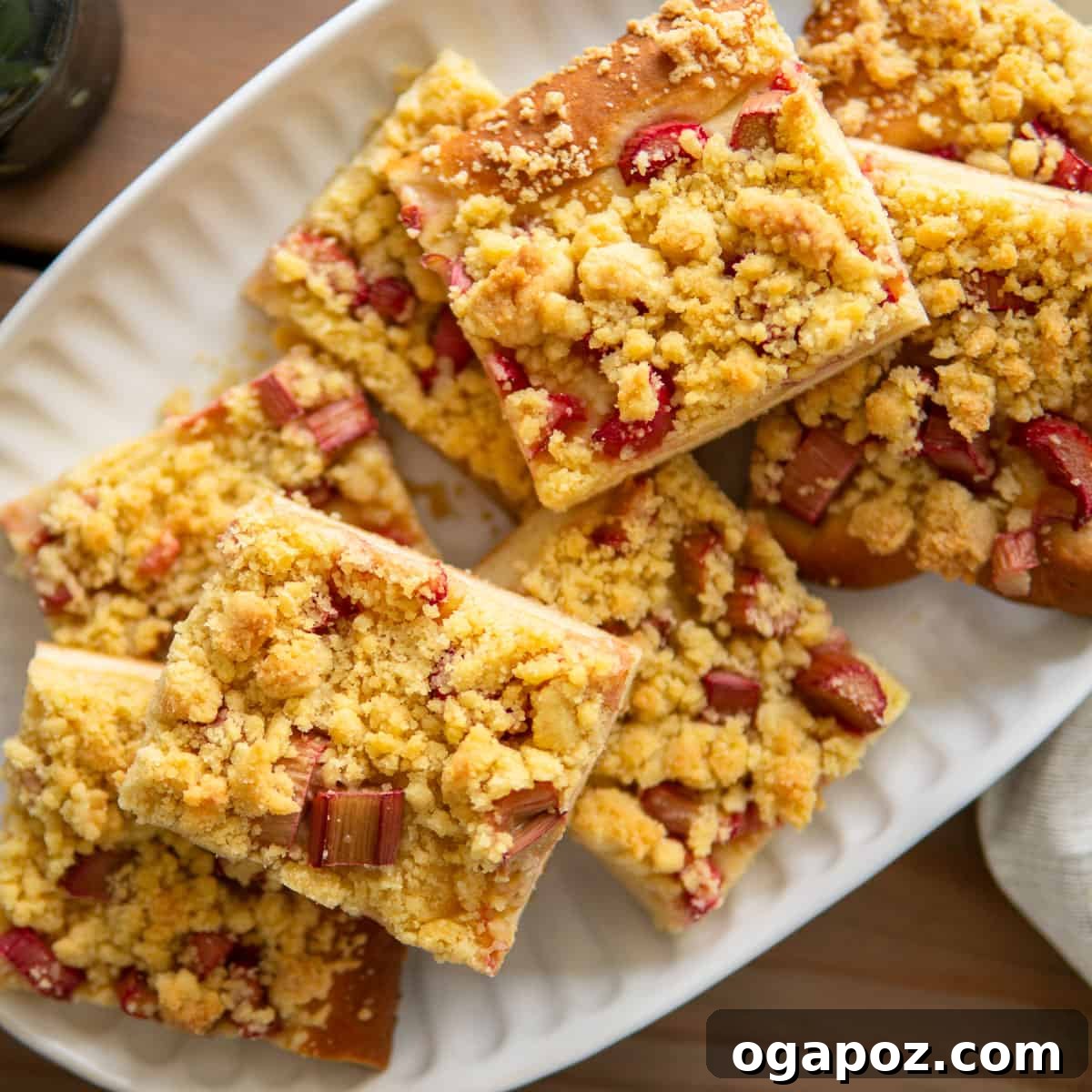 Our Go-To Easy Rhubarb Recipes 27 A rustic and beautifully textured Rhubarb Streusel Sheet Cake with a rich streusel topping, baked in a large pan.