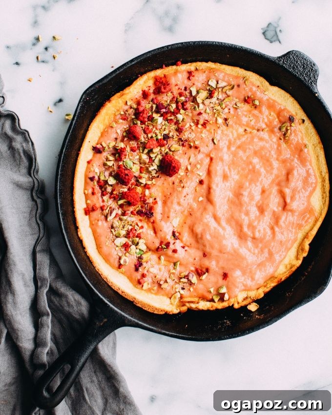 Our Go-To Easy Rhubarb Recipes 9 A dramatically puffed-up Rhubarb Dutch Baby pancake in a cast iron skillet, dusted with powdered sugar.