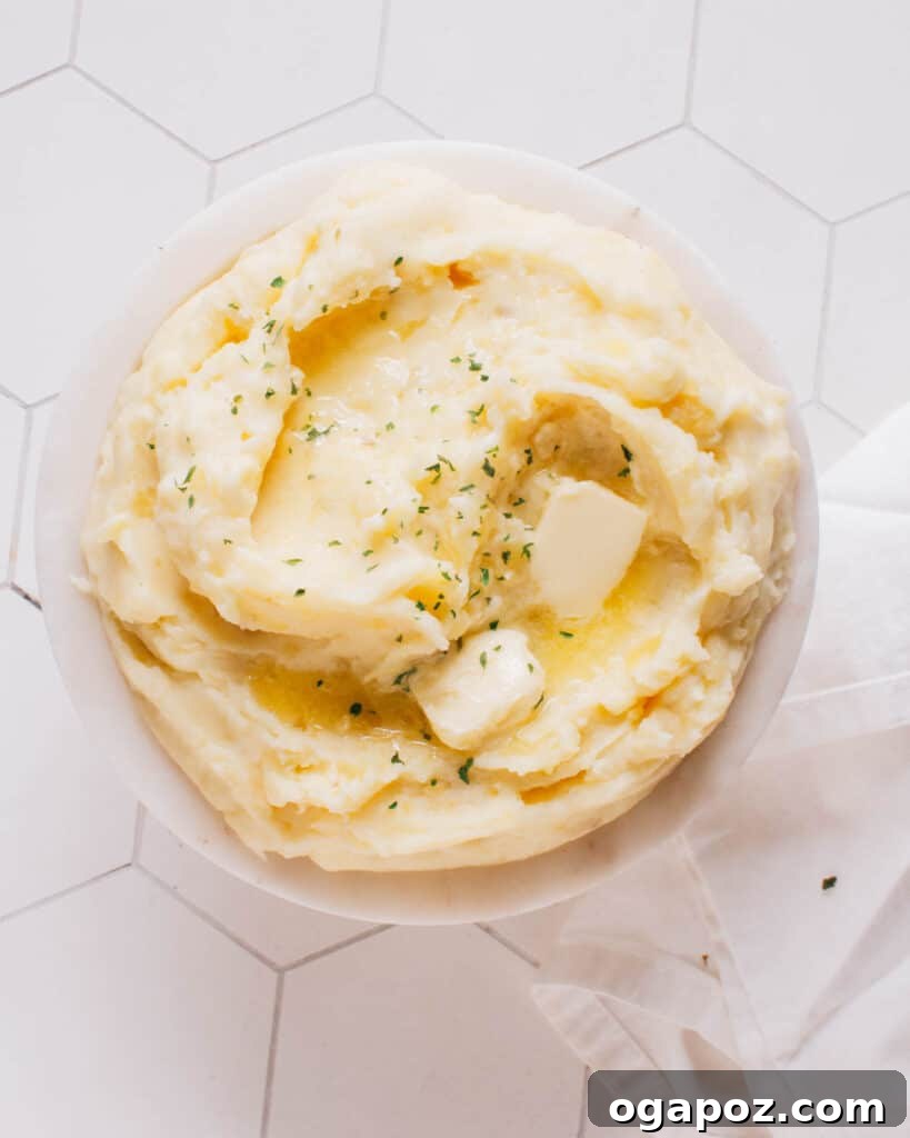 35+ Irresistible Side Dishes for Salmon 13 Mashed potatoes in a bowl with a pat of butter melting on top.