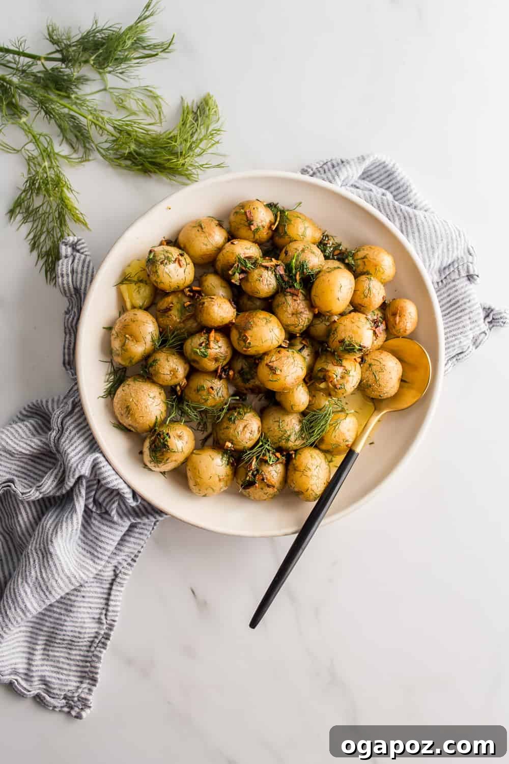 35+ Irresistible Side Dishes for Salmon 17 Boiled Baby Potatoes, garnished with fresh dill.